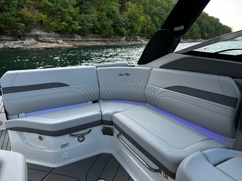 Slide: The Image of 2025 Sea Ray SLX 260 boat interior with luxurious seating and ambient lighting. - 18