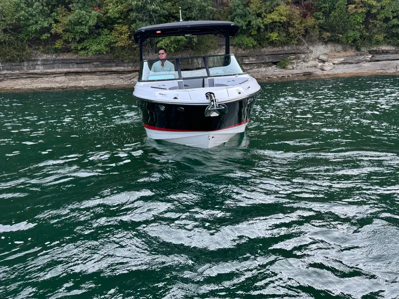 Slide: The Image of 2025 Sea Ray SLX 260 boat on water near rocky shoreline. - 4