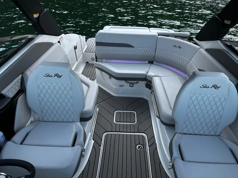 Slide: The Image of 2025 Sea Ray SLX 260 boat interior with luxurious seating and elegant design on the water. - 9