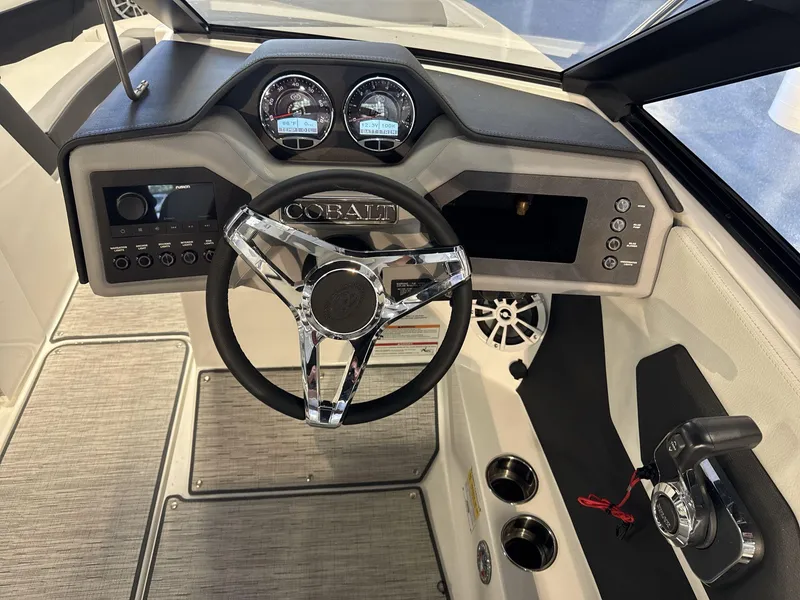 Slide: The Image of 2025 Cobalt CS22 boat dashboard with steering wheel and control panel. - 12