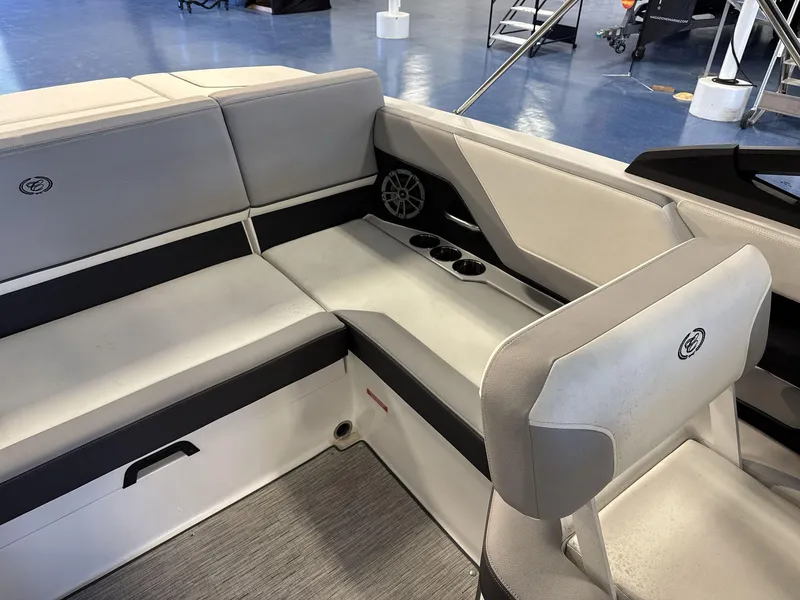 Slide: The Image of 2025 Cobalt CS22 boat interior with gray seating and cup holders. - 14