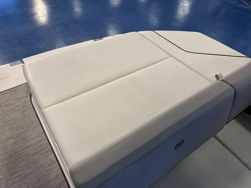 Slide: The Image of 2025 Cobalt CS22 boat interior with white cushioned seating. - 17