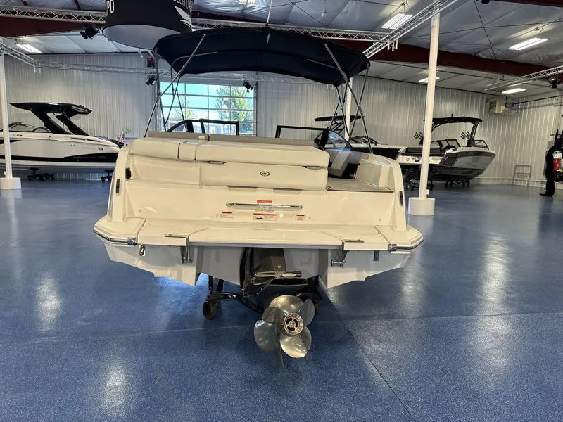 Slide: The Image of 2025 Cobalt CS22 boat displayed in a showroom with blue flooring. - 6