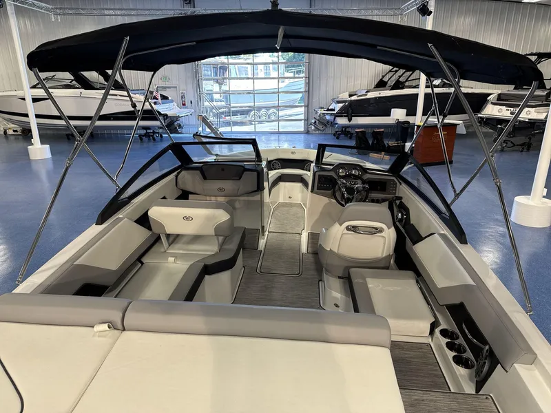 Slide: The Image of 2025 Cobalt CS22 boat interior with seating and steering wheel in showroom. - 8