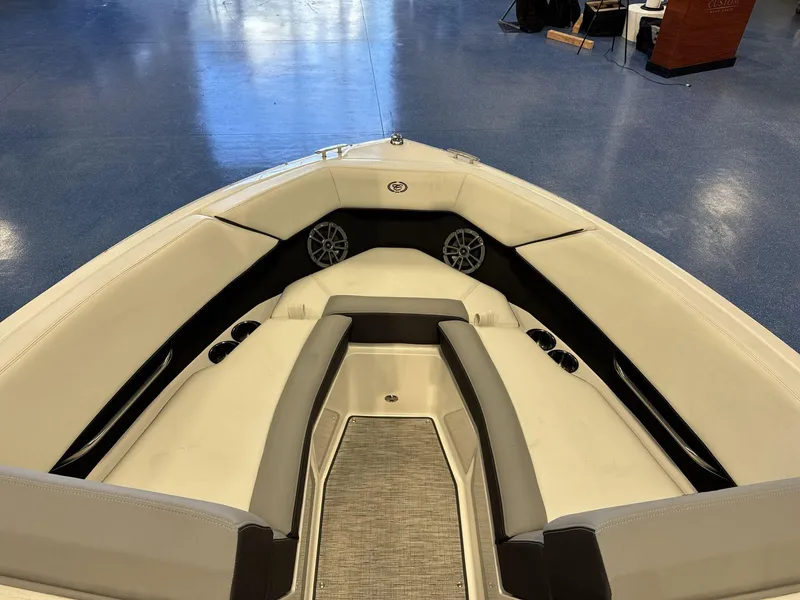 Slide: The Image of 2025 Cobalt CS22 boat interior with white seating and cup holders. - 9