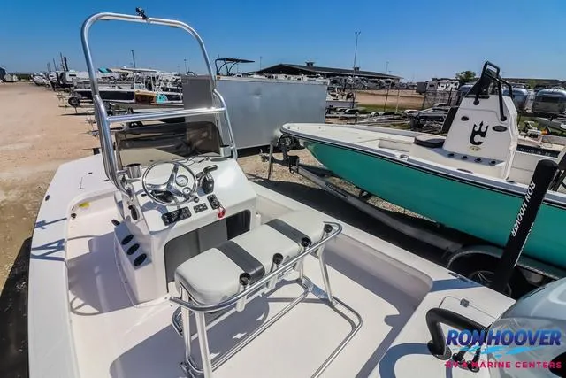 Slide: The Image of 2024 Majek Boats 18 M2 interior with seating and steering console in showroom. - 11