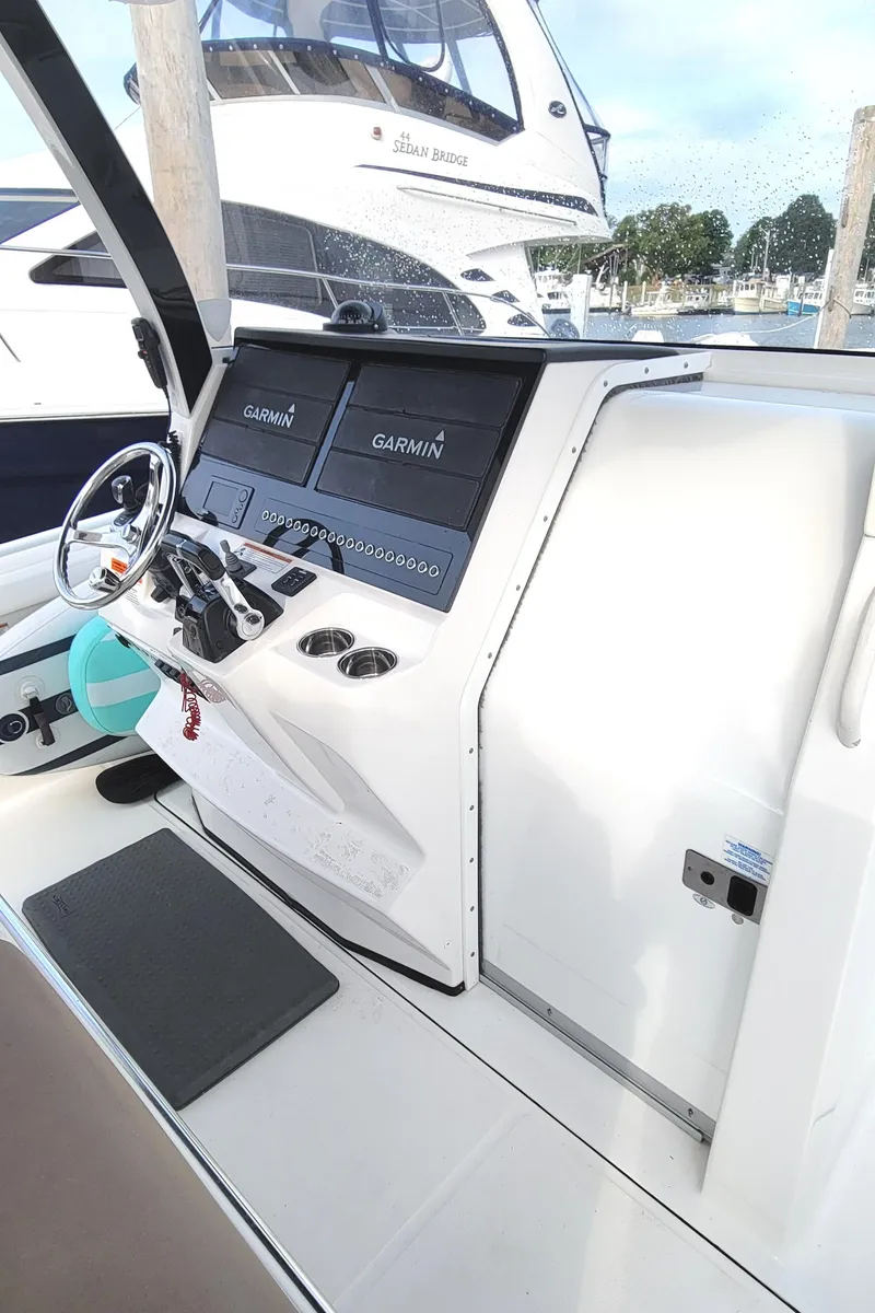 Slide: The Image of 2018 Edgewater 370CC boat cockpit with Garmin navigation system. - 12