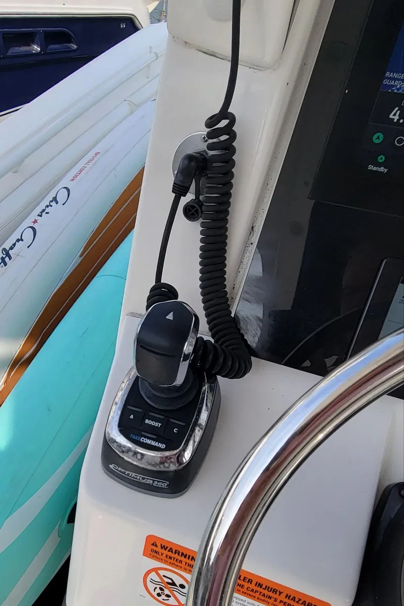 Slide: The Image of 2018 Edgewater 370CC boat control panel with steering wheel and throttle. - 16
