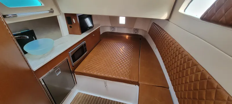 Slide: The Image of Interior of 2018 Edgewater 370CC boat with kitchen and seating area. - 6