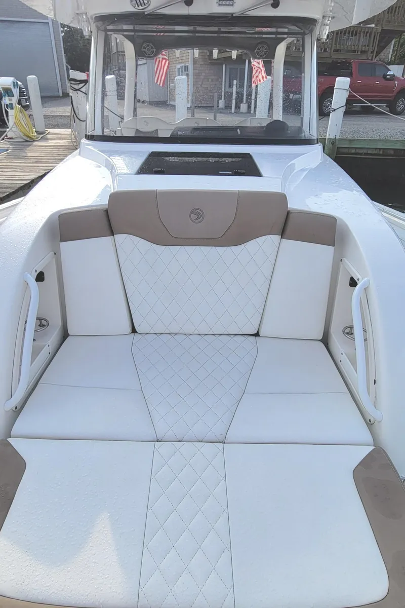 Slide: The Image of 2018 Edgewater 370CC boat with luxurious white seating and diamond stitching. - 9