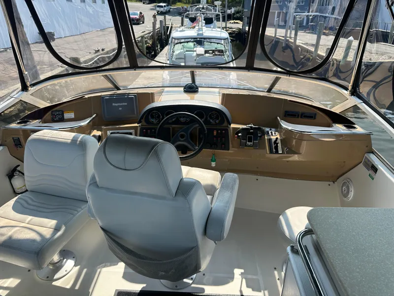 Slide: The Image of 2004 Carver 420 Mariner helm with dual seats and navigation equipment. - 11