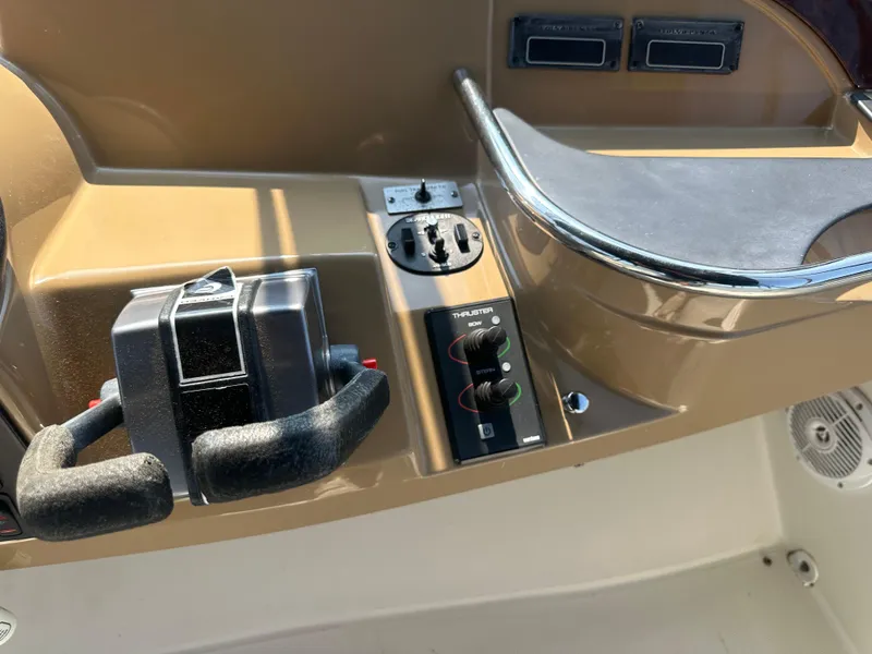 Slide: The Image of Control panel of a 2004 Carver 420 Mariner boat, featuring throttle and switches. - 12