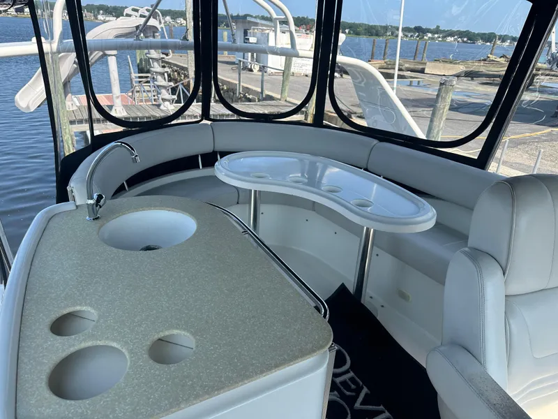 Slide: The Image of 2004 Carver 420 Mariner yacht interior with sink and seating, docked at marina. - 14