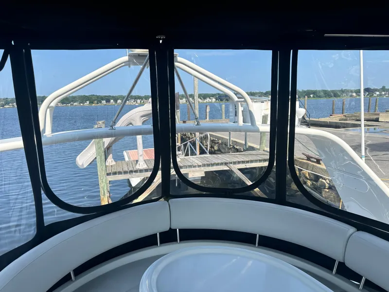 Slide: The Image of 2004 Carver 420 Mariner yacht interior with waterfront view through windows. - 15