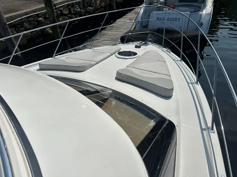 Slide: The Image of 2004 Carver 420 Mariner yacht with sun pads on deck, docked at marina. - 16