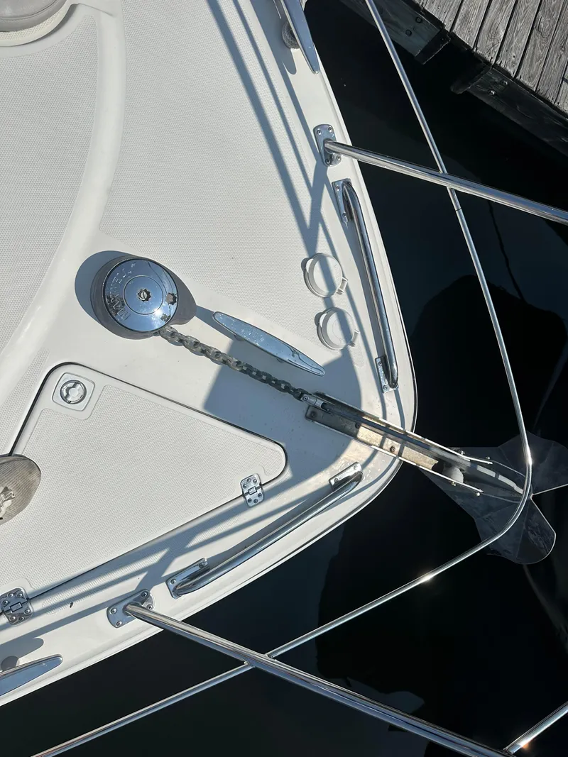 Slide: The Image of 2004 Carver 420 Mariner yacht bow with anchor and railing details. - 17