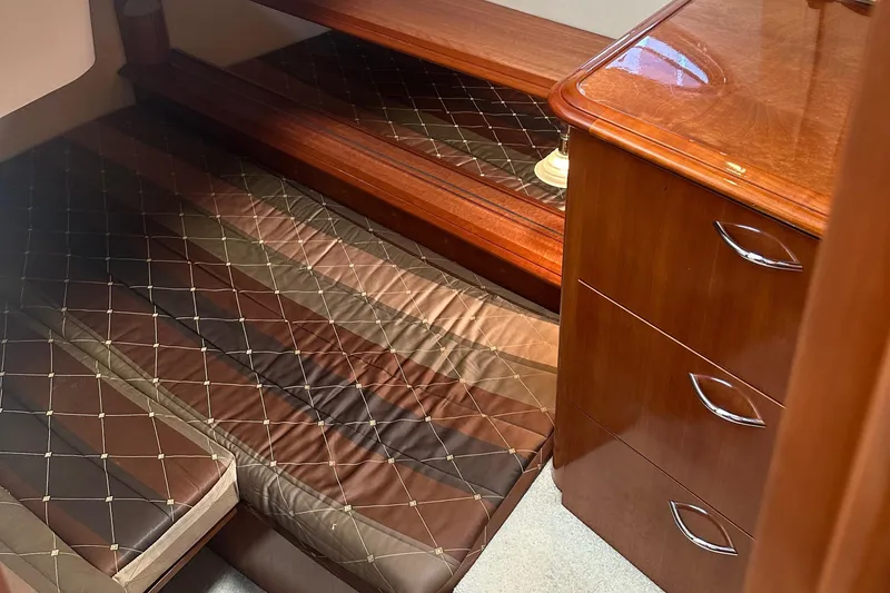 Slide: The Image of 2004 Carver 420 Mariner cabin with wooden furniture and quilted bedding. - 21