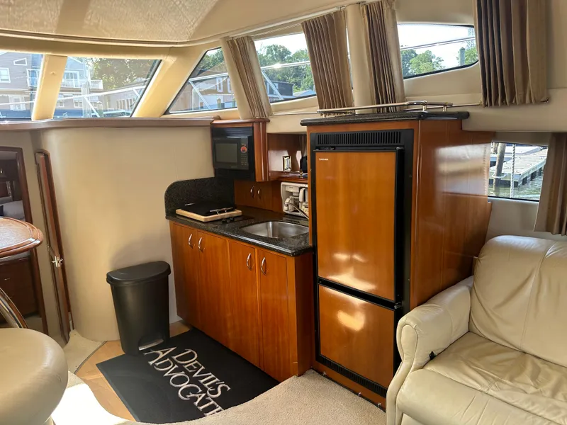 Slide: The Image of Interior of 2004 Carver 420 Mariner yacht with kitchenette and seating area. - 6