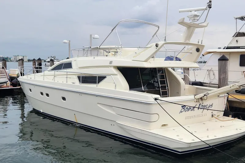Slide: The Image of 1998 Ferretti Yachts 55 Motor Yacht docked at marina. - 1