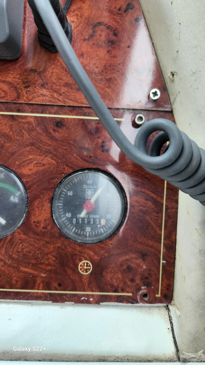 Slide: The Image of Dashboard of a 1998 Ferretti Yachts 55 Motor Yacht with wood paneling and gauges. - 11