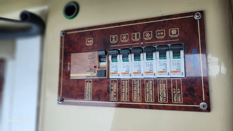 Slide: The Image of Control panel of a 1998 Ferretti Yachts 55 Motor Yacht with labeled switches. - 16
