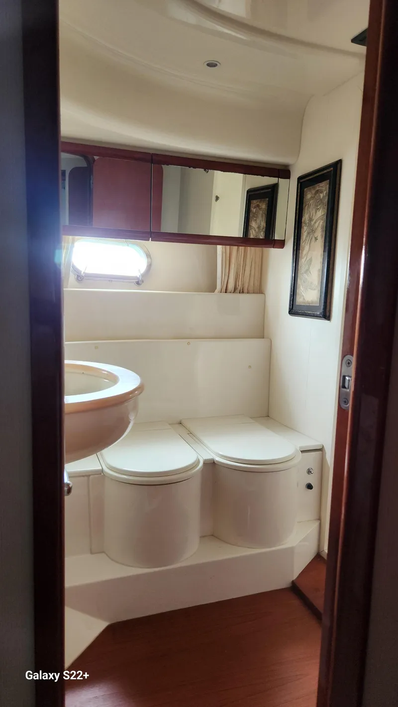 Slide: The Image of Bathroom interior of 1998 Ferretti Yachts 55 Motor Yacht, featuring modern fixtures and wood accents. - 18