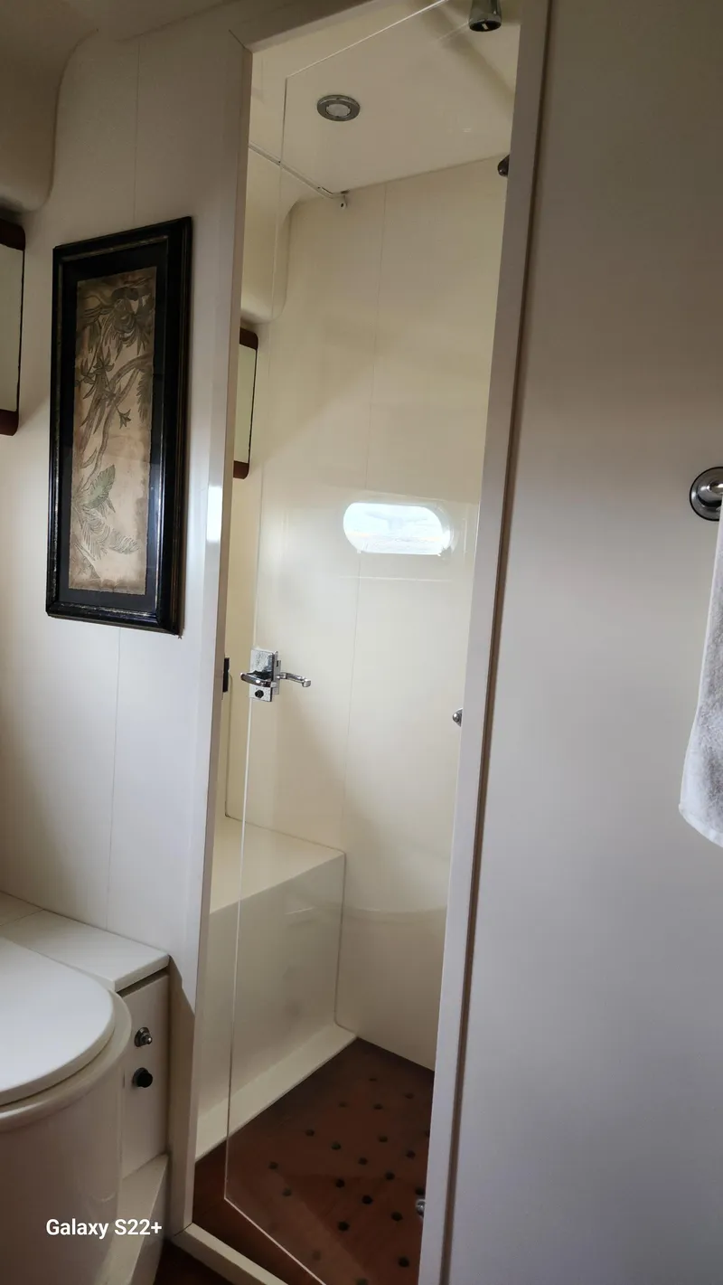 Slide: The Image of Bathroom interior of 1998 Ferretti Yachts 55 Motor Yacht, featuring shower and toilet. - 19