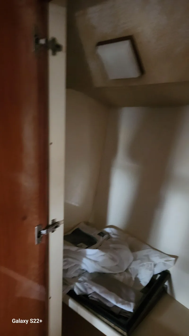 Slide: The Image of Interior cabin of 1998 Ferretti Yachts 55 Motor Yacht, featuring storage space. - 21