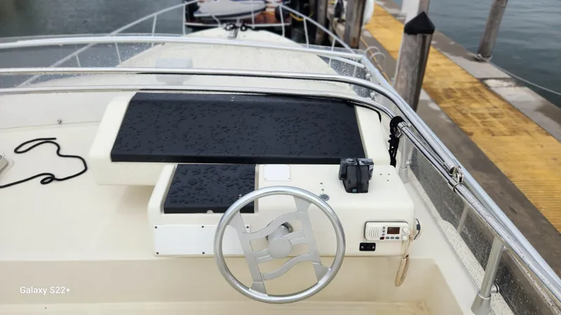 Slide: The Image of 1998 Ferretti Yachts 55 Motor Yacht helm with steering wheel and controls at dock. - 25