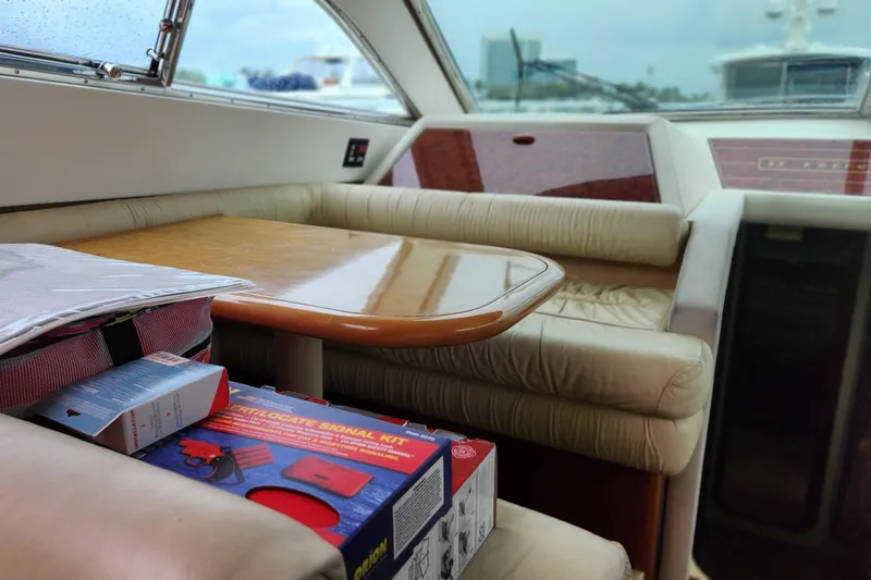 Slide: The Image of Interior of 1998 Ferretti Yachts 55 Motor Yacht with table and safety kit. - 27