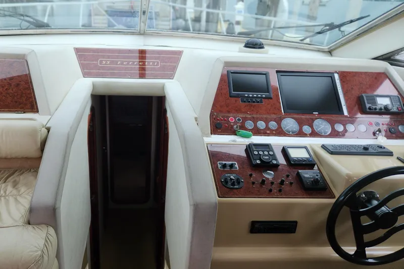 Slide: The Image of Cockpit of 1998 Ferretti Yachts 55 Motor Yacht with navigation controls and displays. - 28
