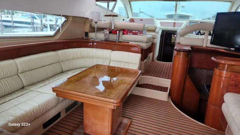Slide: The Image of Luxurious interior of 1998 Ferretti Yachts 55 Motor Yacht with elegant seating and wooden finishes. - 3