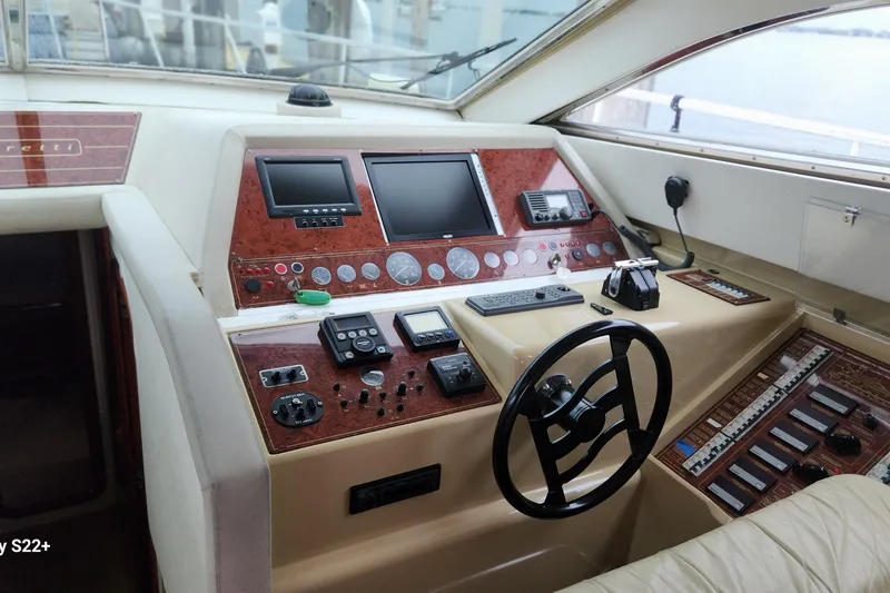 Slide: The Image of Control panel of a 1998 Ferretti Yachts 55 Motor Yacht with steering wheel and navigation instruments. - 30