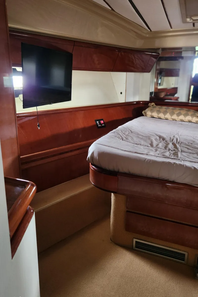 Slide: The Image of Luxurious bedroom interior of 1998 Ferretti Yachts 55 Motor Yacht with TV and elegant wood finish. - 33