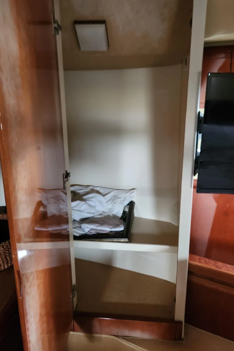 Slide: The Image of Open closet inside 1998 Ferretti Yachts 55 Motor Yacht cabin. - 39