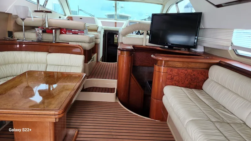 Slide: The Image of Luxurious interior of a 1998 Ferretti Yachts 55 Motor Yacht with elegant seating and wood finishes. - 4