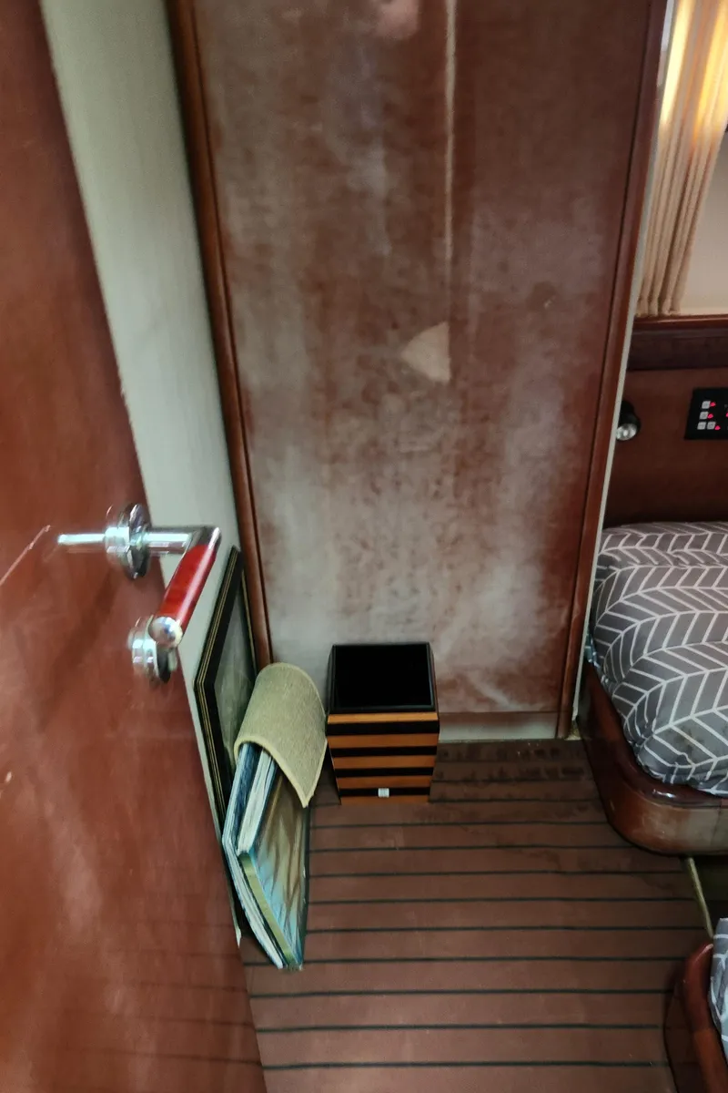 Slide: The Image of Interior of 1998 Ferretti Yachts 55 Motor Yacht with wood paneling and bed. - 40