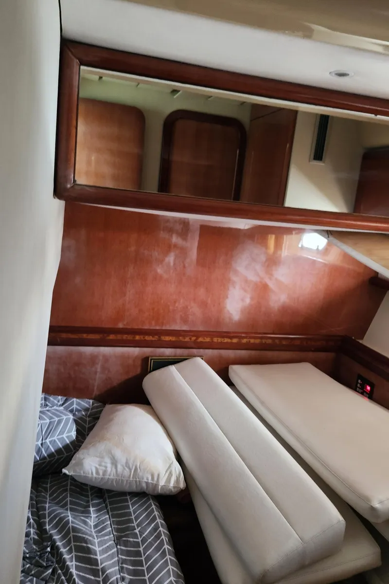 Slide: The Image of Interior cabin of 1998 Ferretti Yachts 55 Motor Yacht with wooden paneling and bedding. - 43