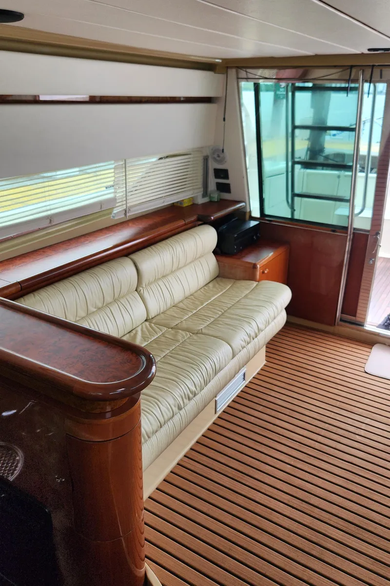 Slide: The Image of Interior of 1998 Ferretti Yachts 55 Motor Yacht with beige sofa and wooden flooring. - 44