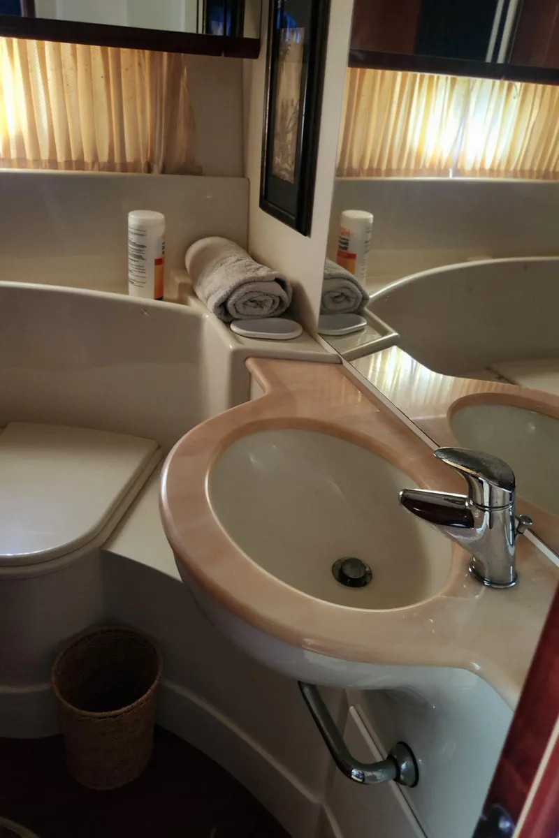 Slide: The Image of Luxurious bathroom in 1998 Ferretti Yachts 55 Motor Yacht with elegant sink and mirror. - 48