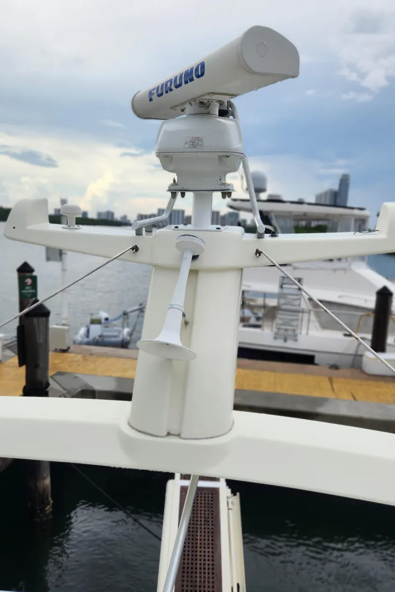 Slide: The Image of Radar equipment on 1998 Ferretti Yachts 55 Motor Yacht, docked with city skyline in background. - 49