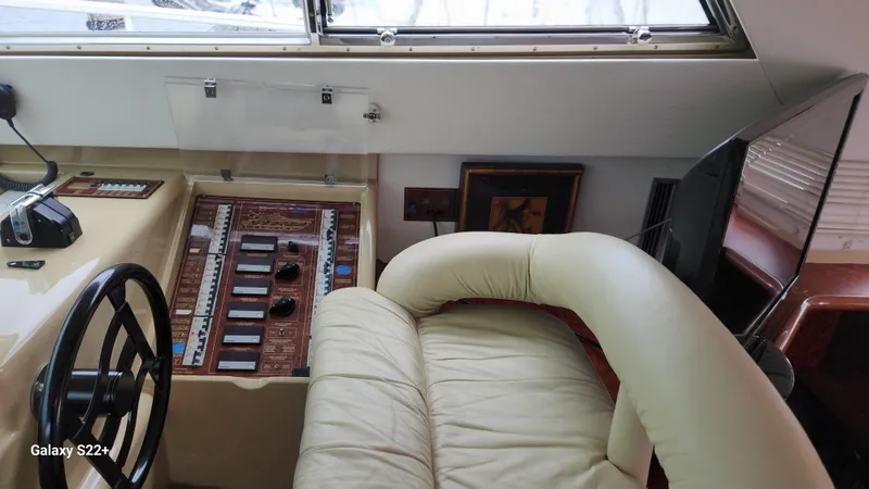 Slide: The Image of Interior helm of 1998 Ferretti Yachts 55 Motor Yacht with leather seating and control panel. - 8
