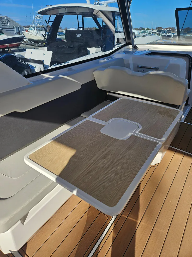 Slide: The Image of 2020 Aquila 36 Sport interior with sleek seating and wooden table design. - 12