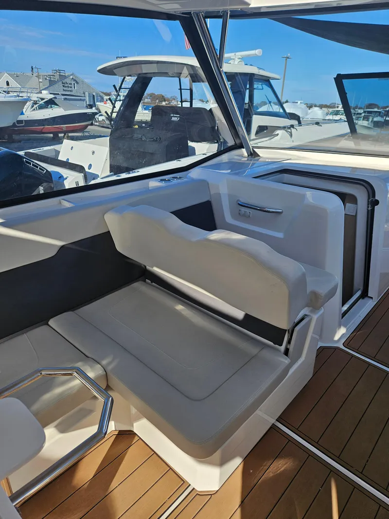 Slide: The Image of 2020 Aquila 36 Sport boat interior with seating and wooden flooring. - 13