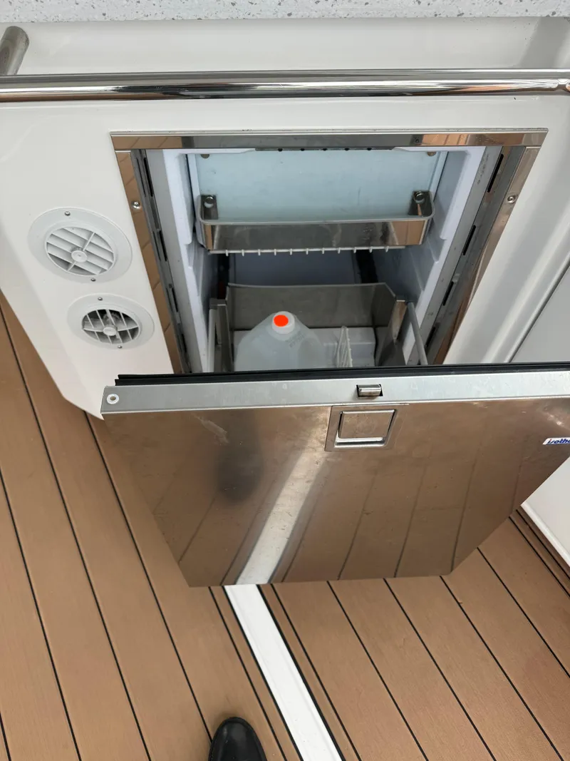 Slide: The Image of Open stainless steel fridge on Aquila 36 Sport 2020 boat deck. - 18
