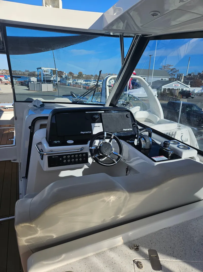 Slide: The Image of 2020 Aquila 36 Sport boat cockpit with modern navigation equipment and steering wheel. - 19