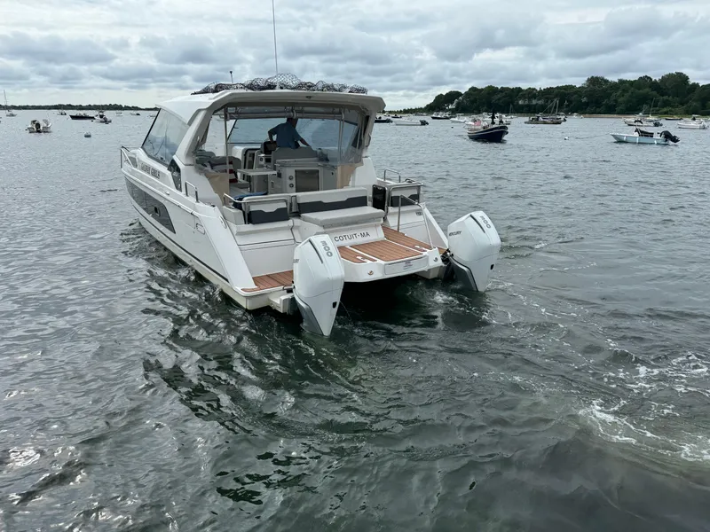 Slide: The Image of 2020 Aquila 36 Sport boat cruising on a calm lake. - 2