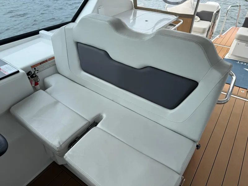 Slide: The Image of Aquila 36 Sport 2020 boat interior with white seating and wooden deck. - 20