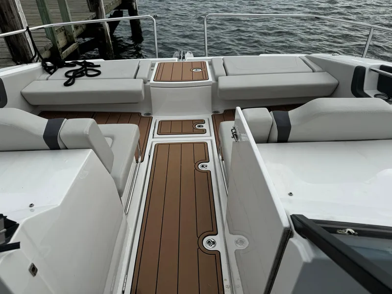 Slide: The Image of Aquila 36 Sport 2020 boat interior with cushioned seating and wooden flooring. - 24