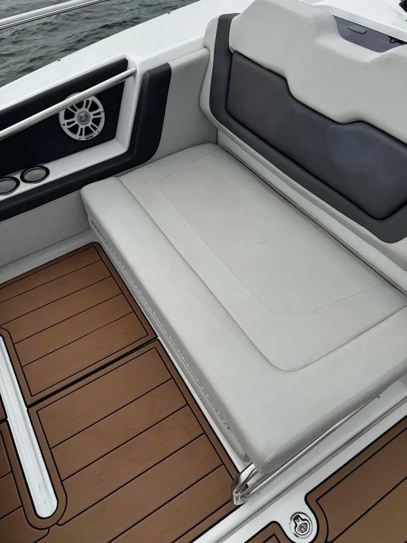 Slide: The Image of Aquila 36 Sport 2020 boat interior with cushioned seating and teak flooring. - 25